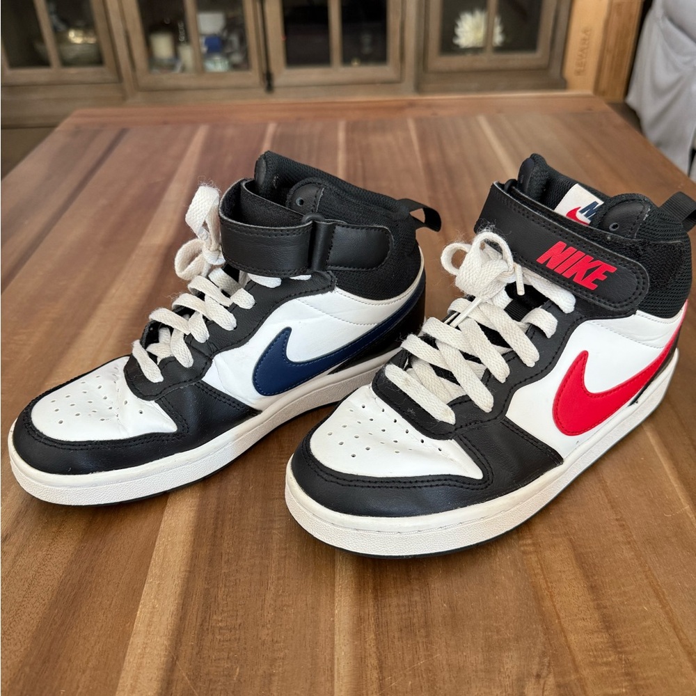 Kids Nike Jordan basketball sneakers size 4.5 black/white with red/blue swoosh.